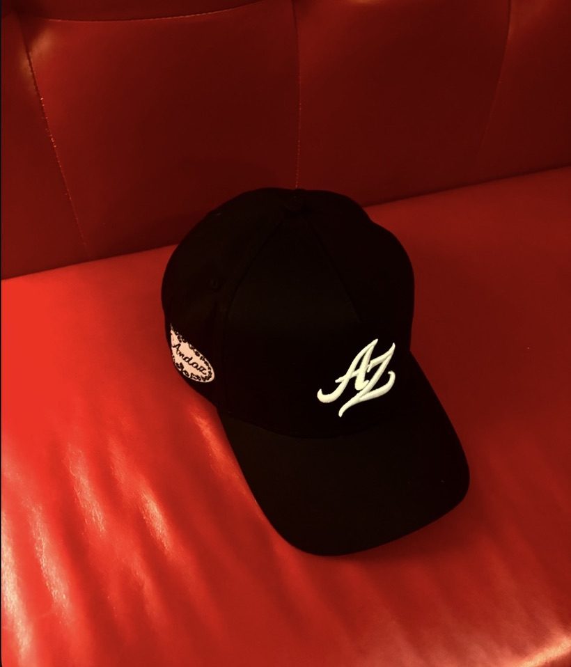 Signature AZ Cap, side, on red leather